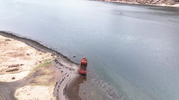 Aerial View Of A WWII US Navy LCM Shipwreck In Mjoifjordur Village, East Iceland. Orbiting High Angl