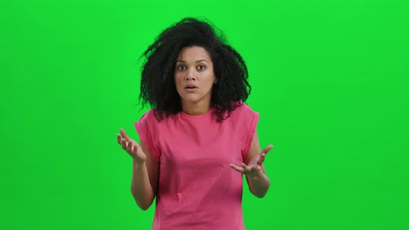 Portrait of Young Female African American Looks Frightened at the Camera and Says Oh My God