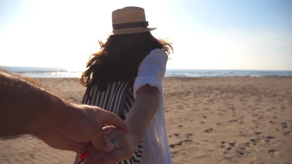 Girl Holding Male Hand and Running on Tropical Exotic Beach to the Ocean