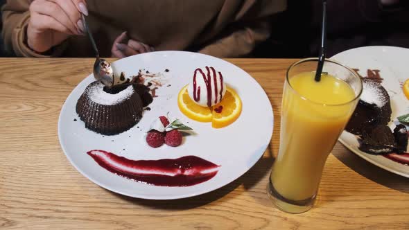 Girlfriends Eating Sweet Dessert in a Restaurant. Chocolate Fondant.