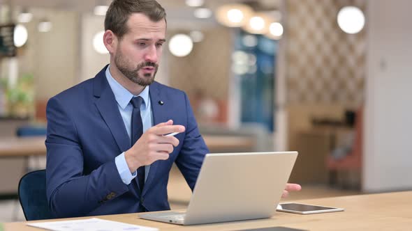 Businessman Doing Video Call on Laptop in Office 