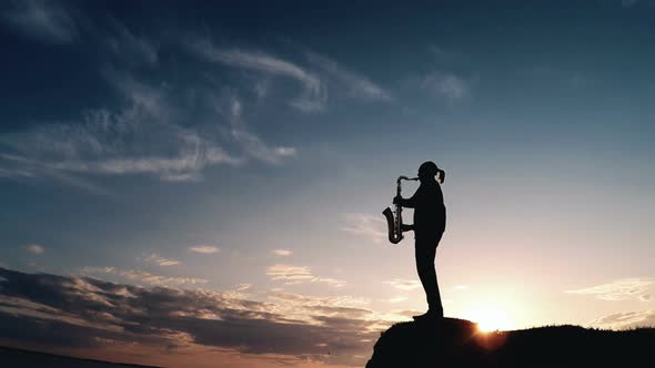 Man Playing the Saxophone at Sunset