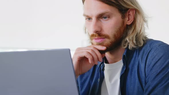 Handsome Young Entrepreneur in Smart Casual Wear Using Laptop