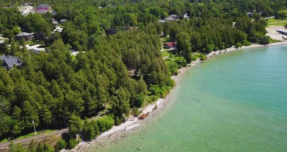 Gorgeous aerial flyover of the turquoise waters of Lake Huron along the Bruce Peninsula.