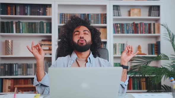 Young Arabian Man Freelancer Engages in Yoga Meditation Sits in Office