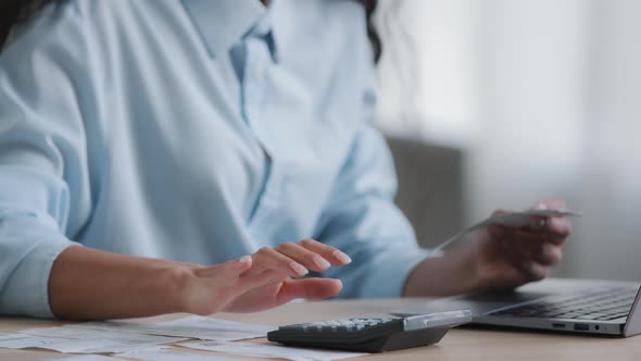 Unknown Young Business Woman Female Accountant Make Calculation of Unpaid Bank Debt Make Electronic