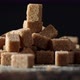 The Brown Sugar Cubes Rotate Slowly on the Table - VideoHive Item for Sale