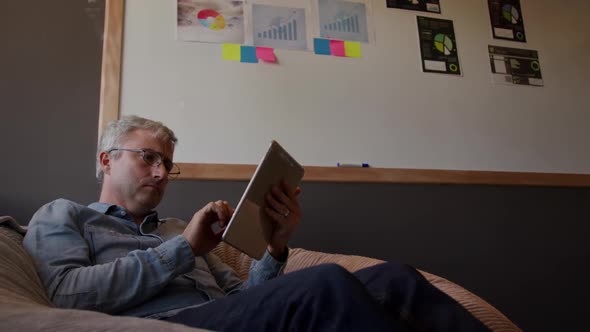 Caucasian man using computer tablet in creative office