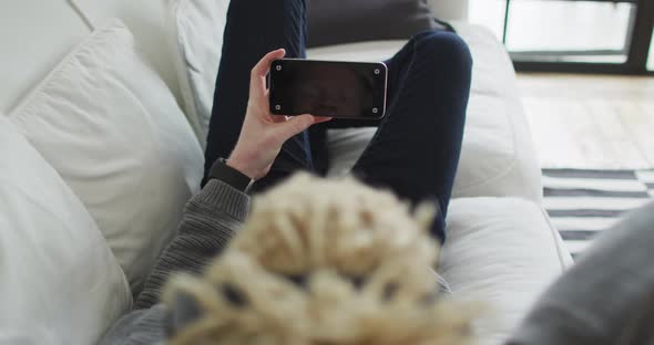 Albino african american man with dreadlocks using smartphone