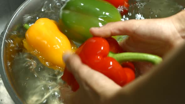 Men's Hands Washing Bell Pepper