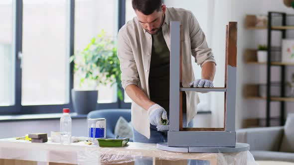 Man Painting Old Table in Grey Color at Home