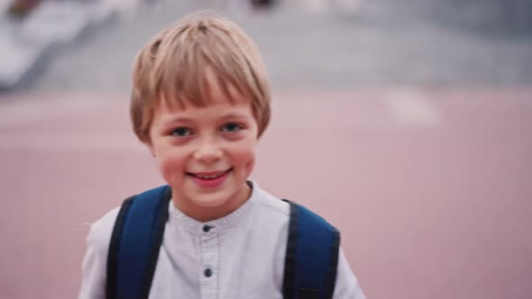 Portrait of 8 Year Caucasian Boy Looking to the Camera and Smile with Dimples on Cheeks