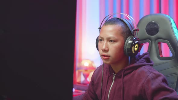 Serious Boy Playing Computer Game In Living Room