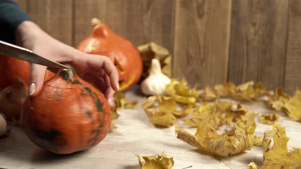 Cutting Out the Top of a Pumpkin for a Halloween Lantern Decoration