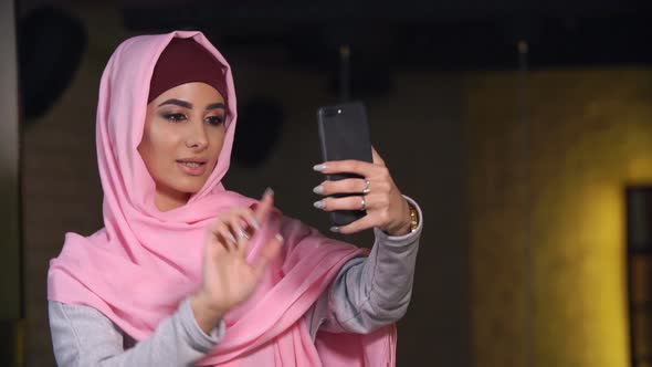 Young Beautiful Woman in Hijab Doing Selfie on Mobile Phone Camera. Muslim Woman and Modern