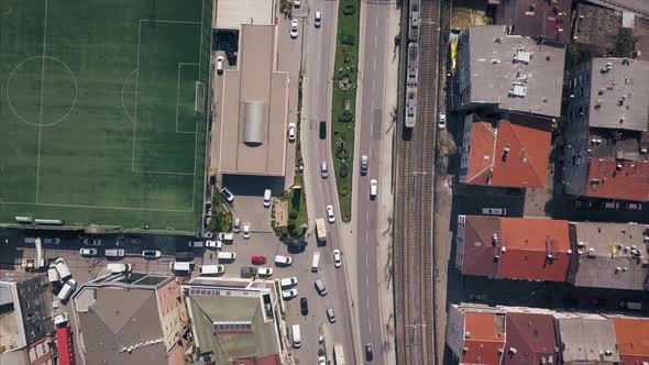 Aerial Top View Of Train Rail And Train Goes Next To Highway