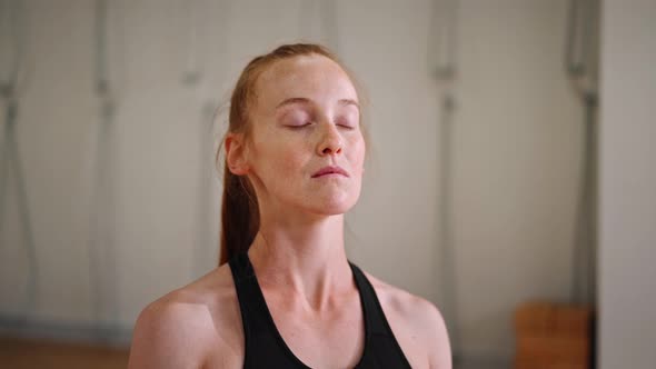 Close up: athletic woman doing yoga for health. The girl is in the lotus position