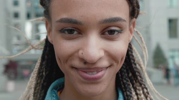 Happy Young African American Woman Laughing Standing in Skyscrapers Background