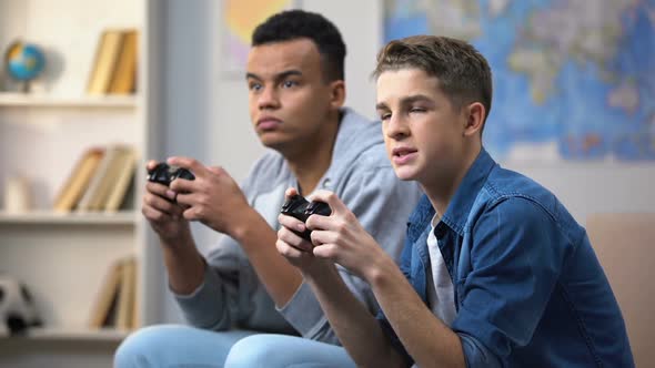 Afro-American and Caucasian Friends Unhappy With Losing Video Game, Addiction