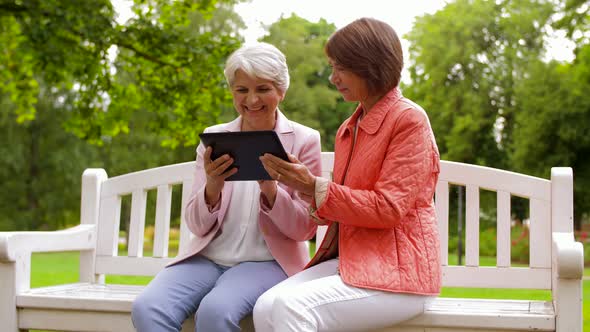 Senior Women with Tablet Pc at Summer Park