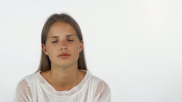 Young Woman Waking Up Her Sleepy Friend with an Alarm Clock