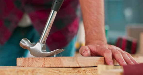 the Carpenter Wearing a Red Flannel Shirt Jeans and Cloth Protective Gloves Pulls Out a Badly Driven