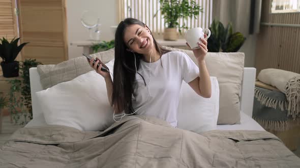 Girl Listening Music in Bed