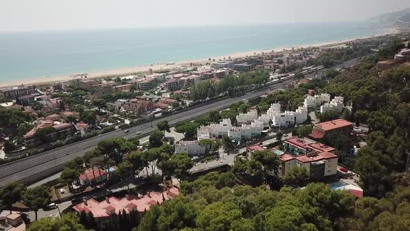 Drone footage passing above a building and going to the sea