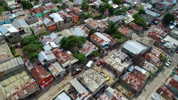 Aerial view overlooking streets and rooftops in a slum district of Mexico city, cloudy day - rising,