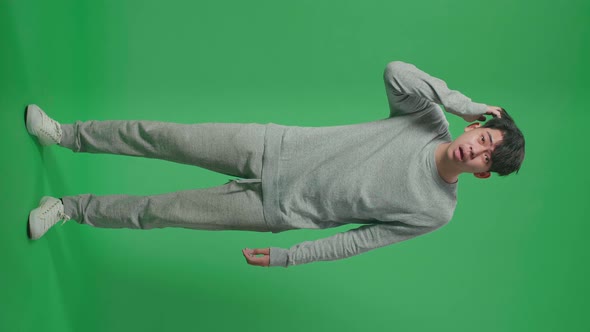 Full Body Of Puzzled Asian Man Is Standing In Front Of Green Screen Background