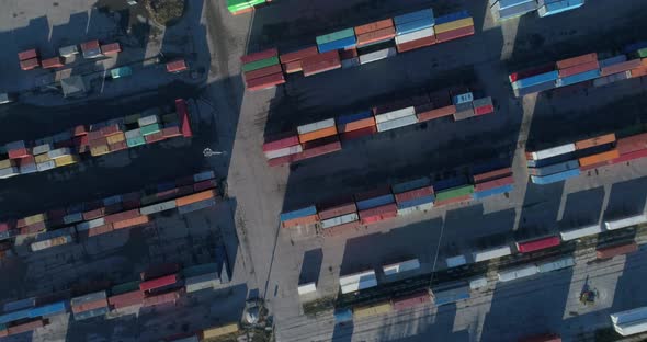 Top down view of colorful containers piles in port container terminal, industrial cargo harbor