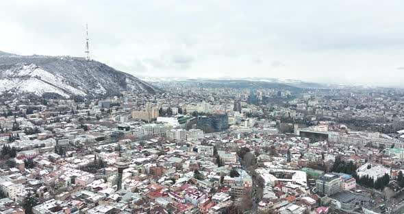Aerial view of center of Tbilisi under Mtatsminda mountain, Georgia 2022 winter