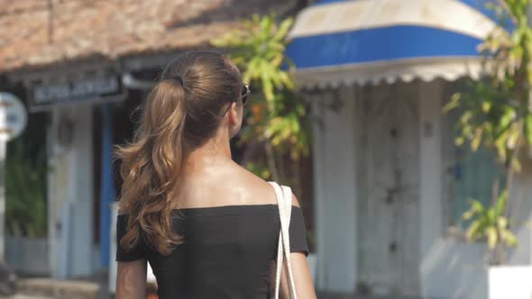 Happy Tourist Walks Along Old Quarter Looking for Cafe