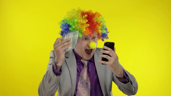 Clown Businessman Entrepreneur in Wig Receives Money Cash Income. Work Online