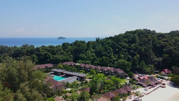 Aerial View of Topical Modern Resort with Green Palm Trees and Swimming Pool