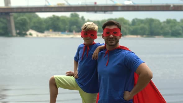 Father and Son as Superheroes Posing for Camera, Concept of Teamwork and Support