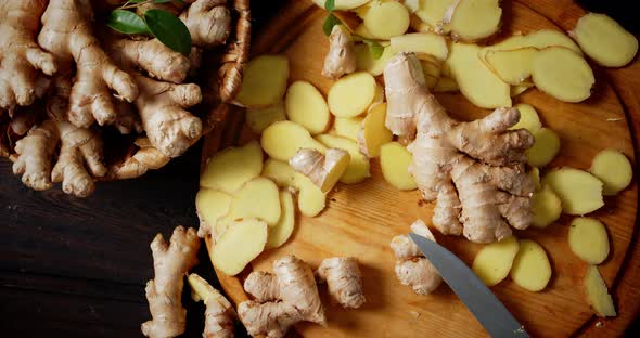 Slices of Fresh Ginger on the Cutting Board Slowly Rotate. 