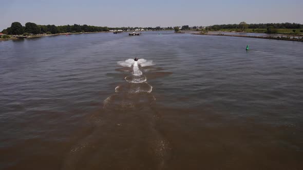 Wake Behind A Fast Moving Jetski On The River During Summer. - Aerial Tracking Shot