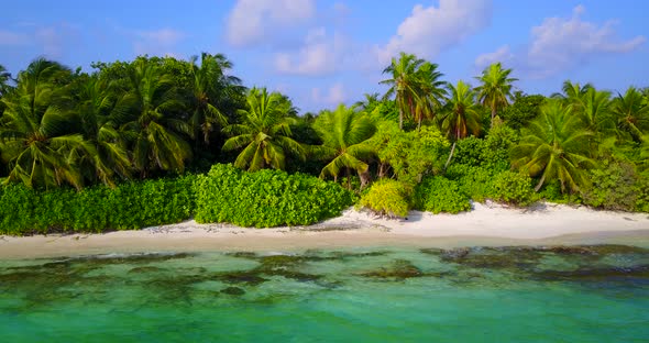 Daytime aerial tourism shot of a white sand paradise beach and aqua turquoise water background in co