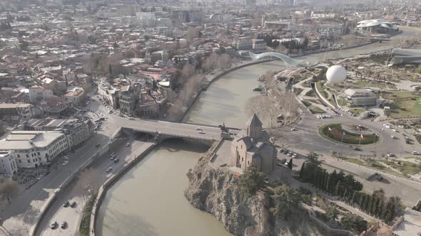 Aerial view of Metekhi church in old Tbilisi located on cliff near river Kura. Georgia 2021 Spring