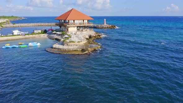 Captain Kidd seafront restaurant at La Romana in Dominican Republic. Aerial forward drone view
