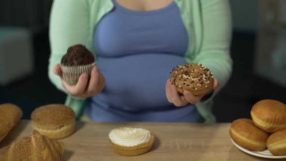 Overweight Girl Holding Muffin and Donut, Overeating Sugar, Risk of Diabetes