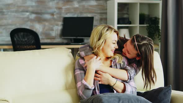 Cheerful Little Daughter Hugging Her Mother