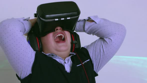 The Boy in the Augmented Reality Headset Laughs a Little and Waves His Hands