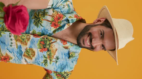 LAtin Handsome Bearded Man Gives a Gift and a Red Rose on Camera Vertical Shot