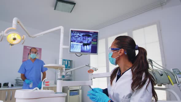 Dentist Doctor and Patient Looking at Digital Teeh Xray