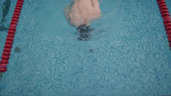 Professional Swimmer Practicing in Pool