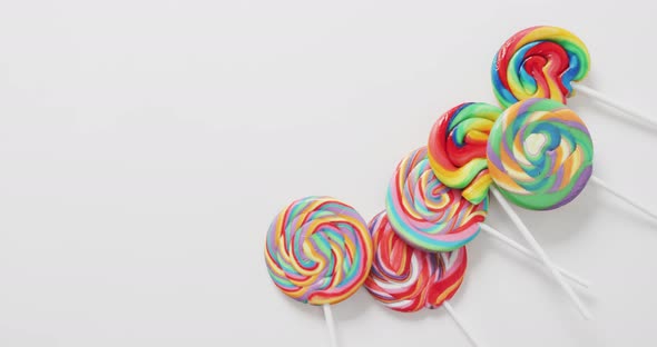 Video of rows multicoloured lollipops on white background