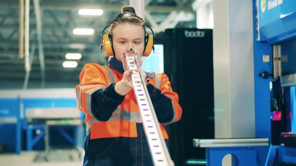 Metal Bar is Getting Closely Observed By a Female Engineer