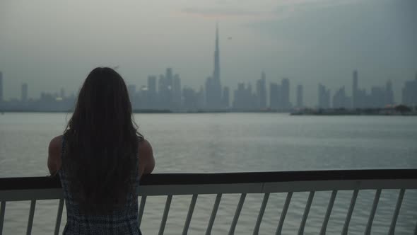 Woman Looking at Dubai Skyline Across the Water